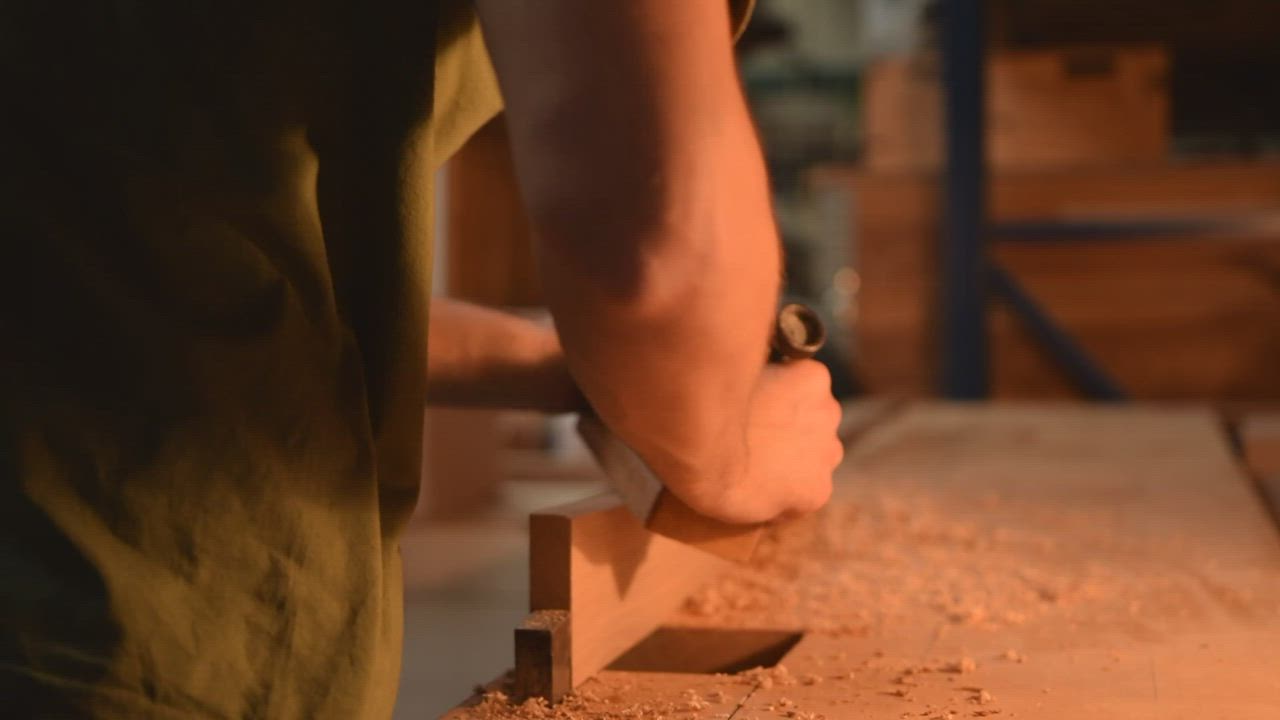 Carpenter sanding a wood in his workshop - Free Stock Video