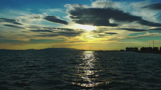 The sea, the sky and a city on horizon.