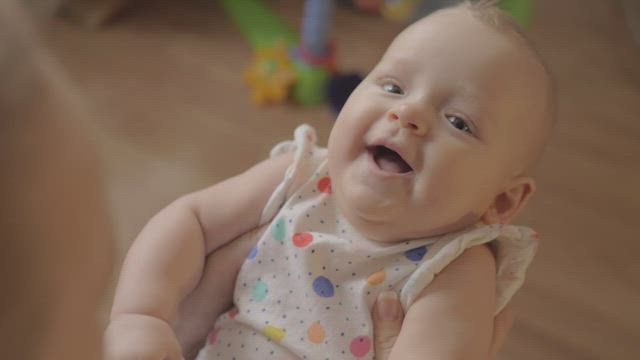Mother making her baby smile.