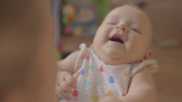 Infant laughing with her Mother.