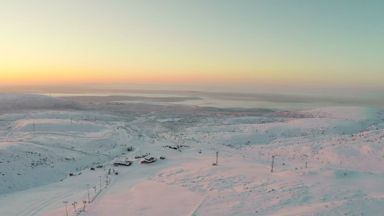 Sunrise from a snow covered mountain - Free Stock Video