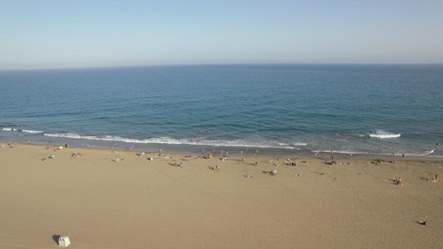 Large beach with people.