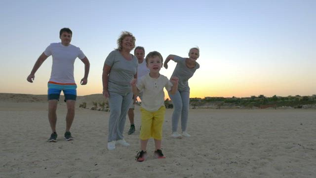 Family jumping at the beach.