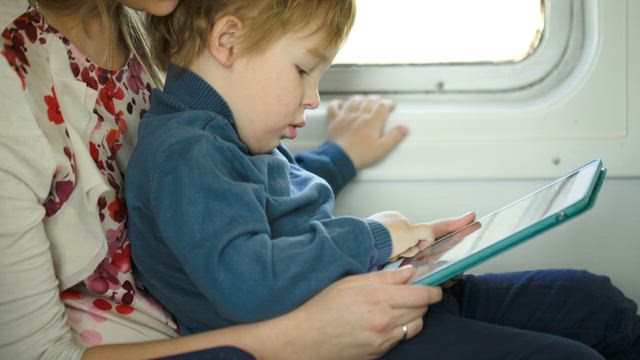 Mother and young child using a tablet.