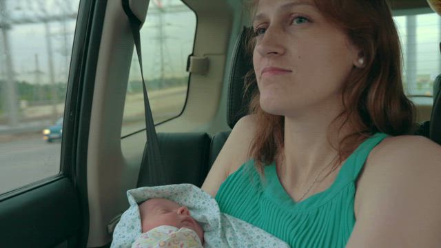 Mother and newborn driving home.