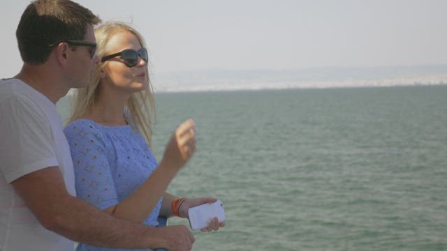 Couple taking a photo together on a boat.