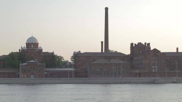 Boats heading past a prison in Saint Petersburg.