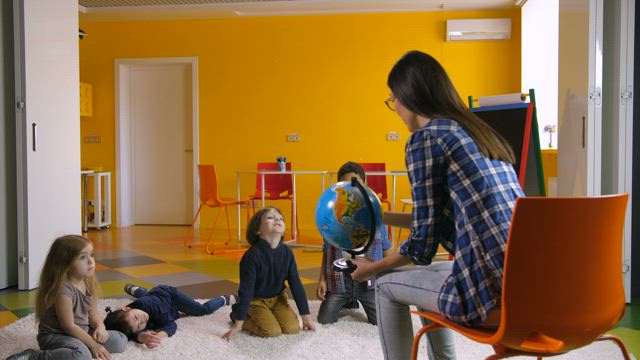 Geography teacher with young students.