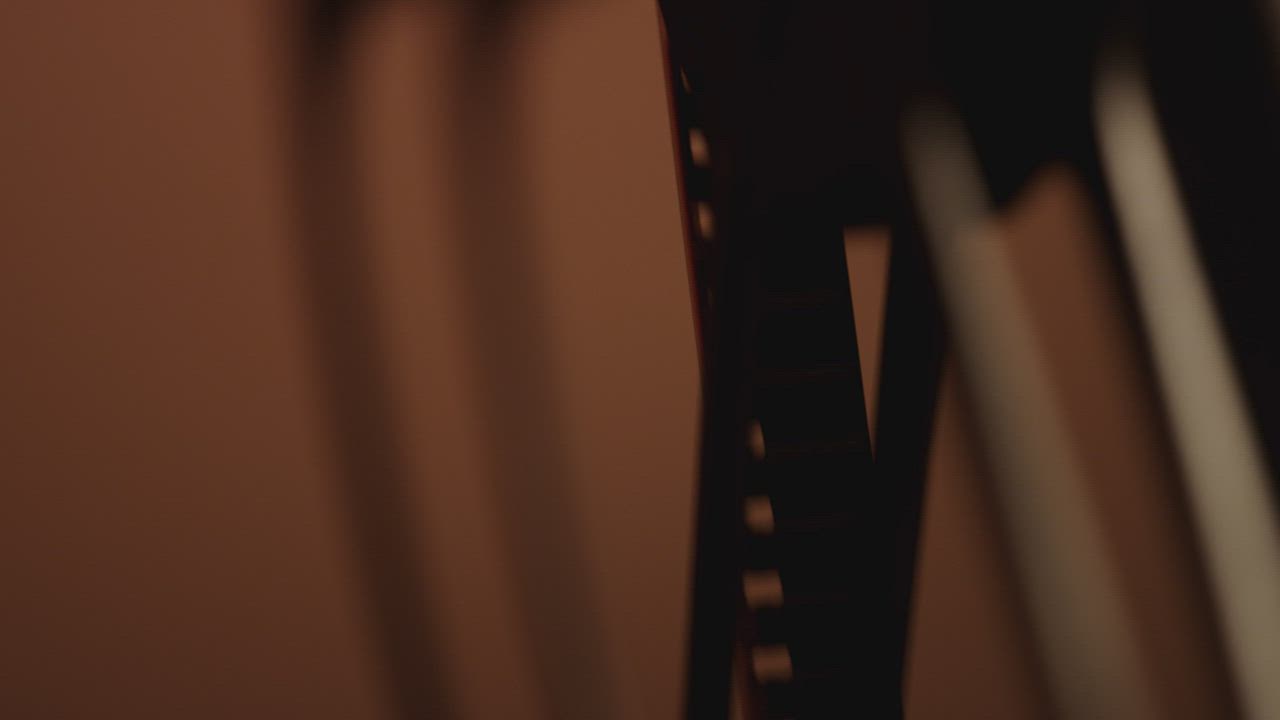 Silhouette of an old film spinning - Free Stock Video
