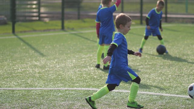 Soccer player kicking a ball during training.