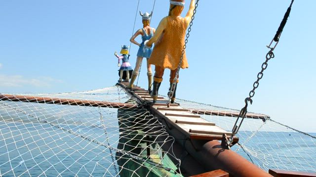 Figurines at the front of a ship.