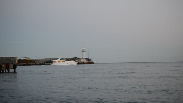 Beautiful white boat leaving port.