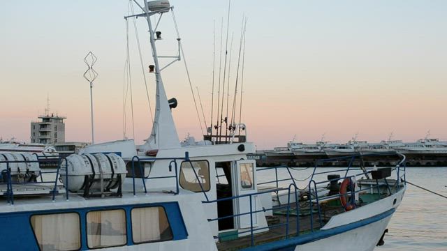 Yacht moving gently in port.