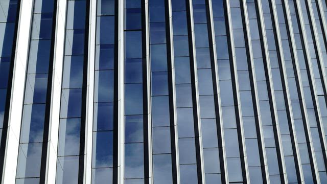 Clouds reflecting on a large building.