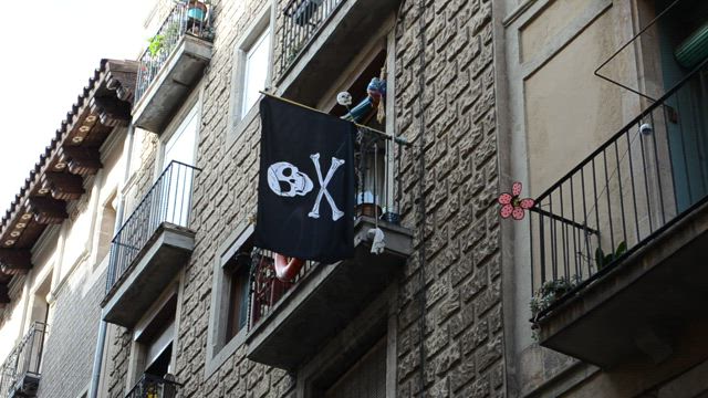 Pirate flag hanging from a balcony.