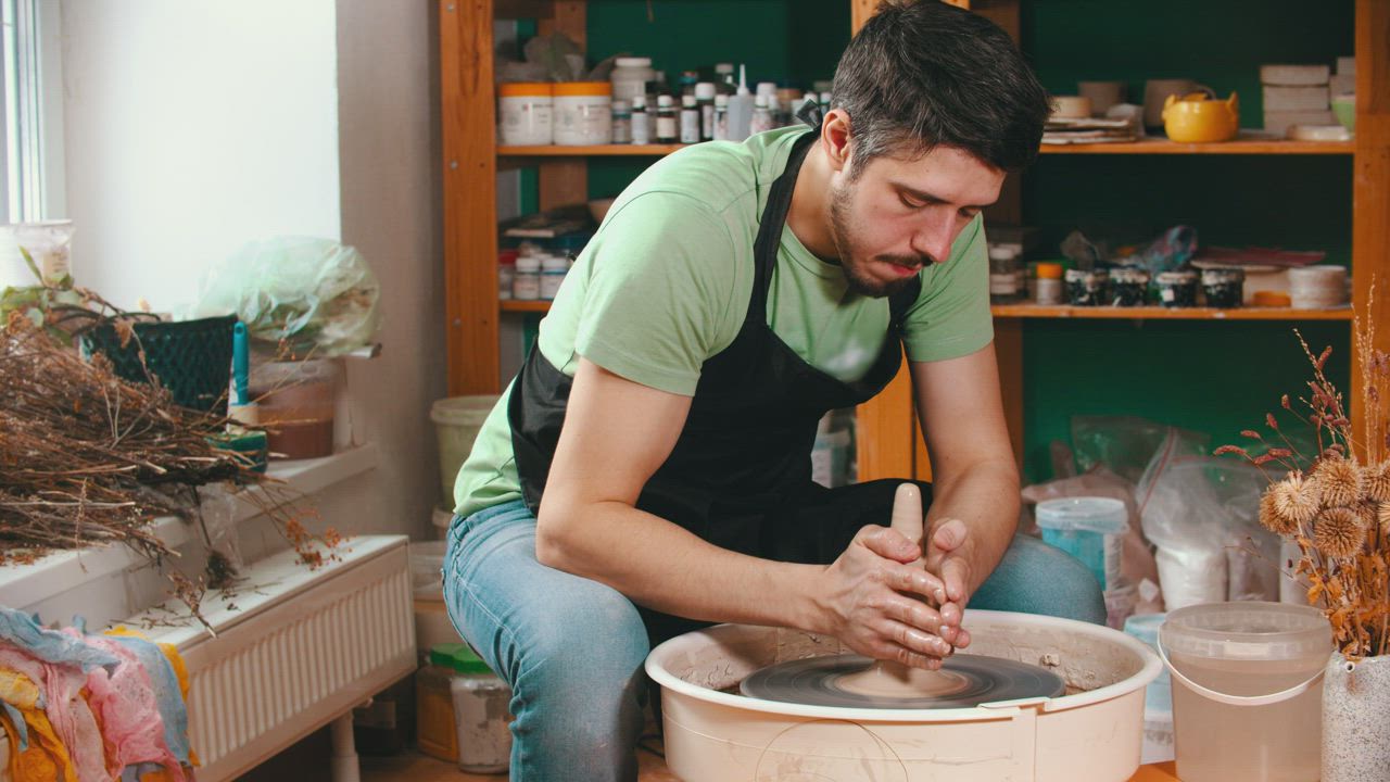 Man working with clay in the pottery studio - Free Stock Video