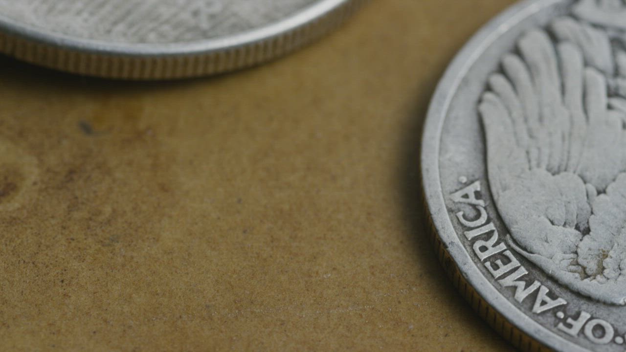 Rotating close up footage of coins on the table.