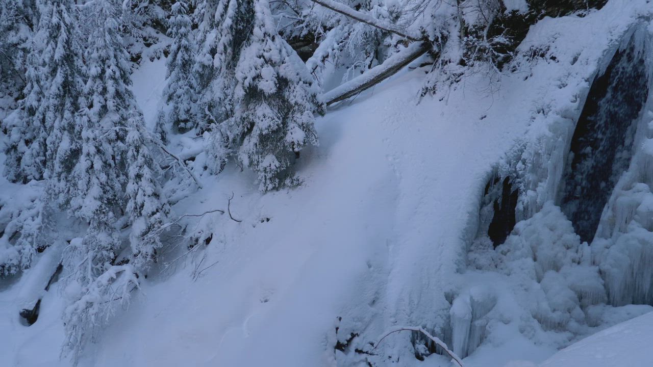 Frozen winter waterfall in the mountains - Free Stock Video