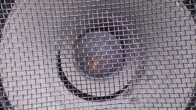 Close up of a speaker vibrating.