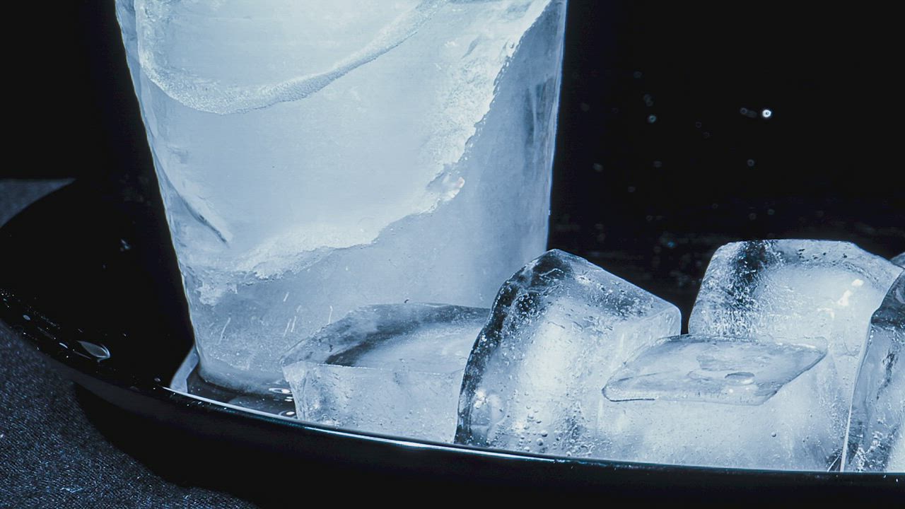 Ice cubes melting on a black surface - Free Stock Video