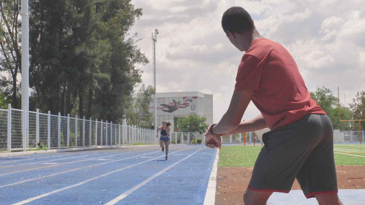 Man taking time to a girl running - Free Stock Video