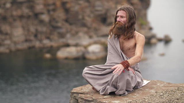 Spiritual man meditating by the sea.