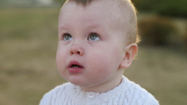 Little baby looking up at the sky, portrait.