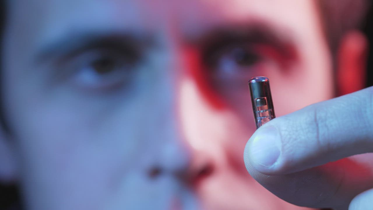 Man holding a small microchip - Free Stock Video