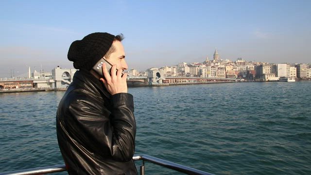 Man in a call standing on a boat.