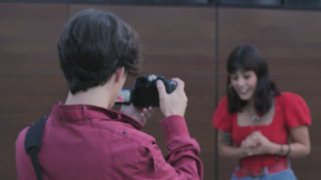 A boy and a girl shooting a story on the street.
