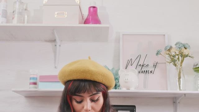 Young woman recording a makeup tutorial with his phone.