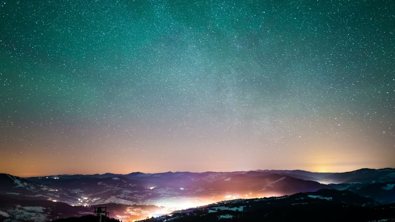 Starry sky over a village in the mountains - Free Stock Video