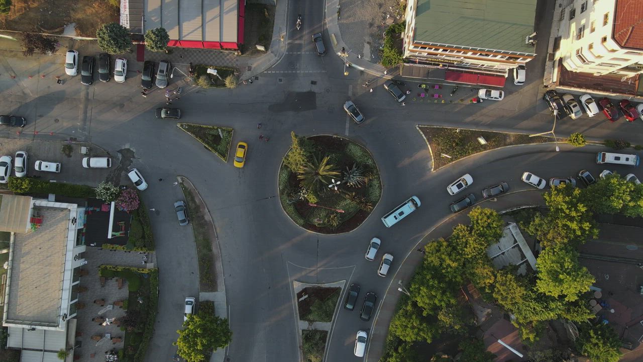 Little roundabout with traffic, top aerial view - Free Stock Video