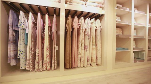 Interior of a large closet very organized.