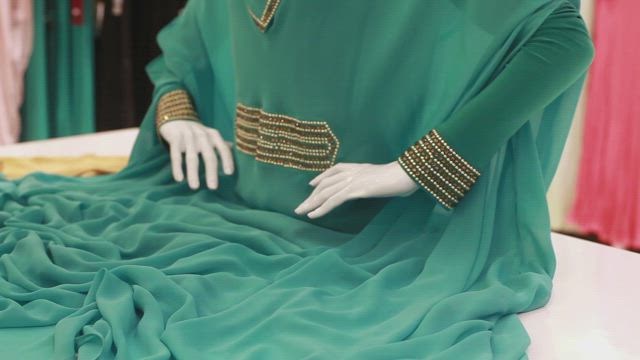 Arranging a pair of elegant slippers and a dress.