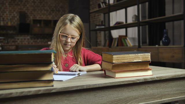 Girl frustrated while studying throws a books away.