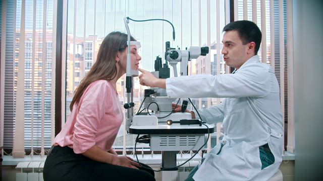 Ophthalmologist and a patient during an eyesight test.
