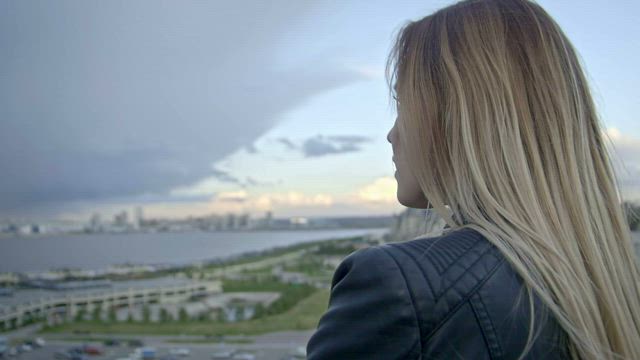 Young woman observing the horizon from above.