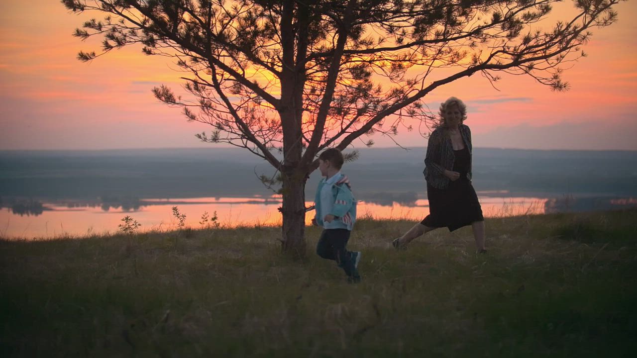 Grandmother with grandchild at sunset