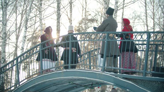 Russian folklore people dancing on a bridge .