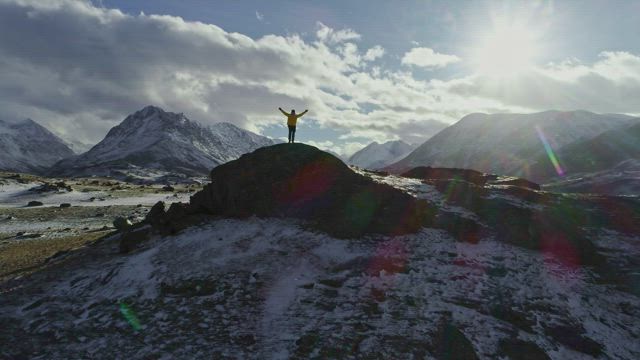 Climber enjoying freedom on top of a cliff.