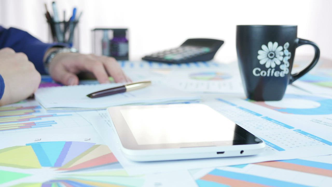 Person doing accounts with a tablet - Free Stock Video