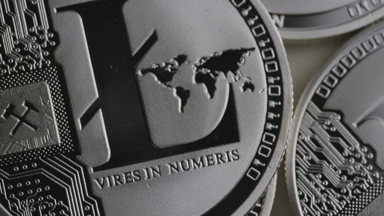 Texture of silver Litecoin coins slowly rotating - Free Stock Video