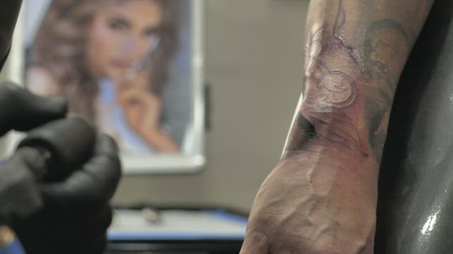Tattooing a forearm .