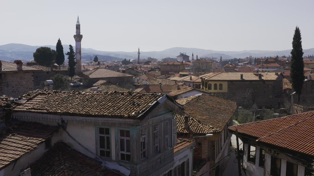 Aerial view above the rooftops of a village - Free Stock Video