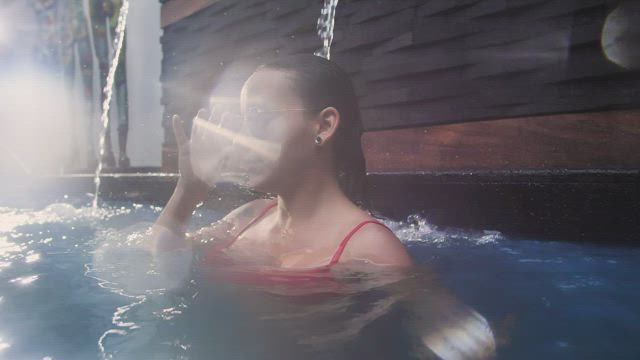 Portrait of a young woman in swimming pool.