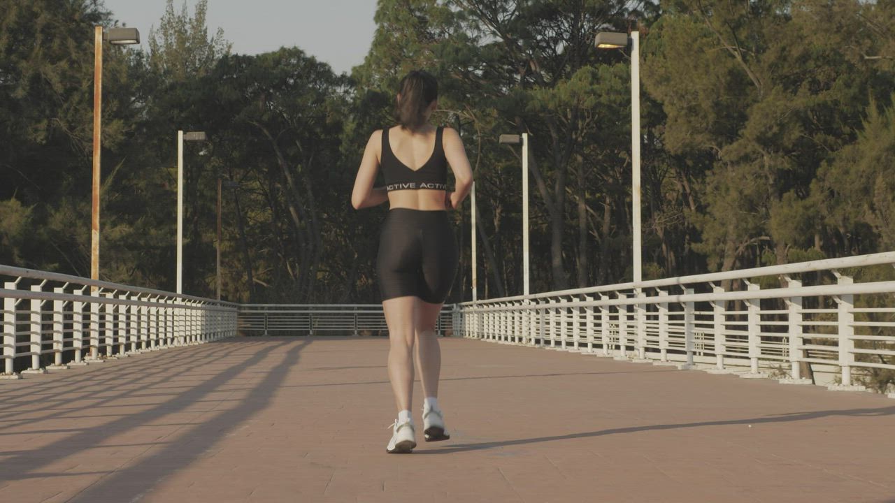Girl in sportswear jogging outdoors - Free Stock Video