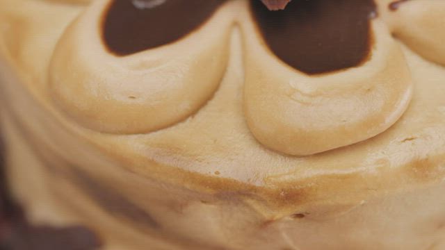 Texture of a cake with chocolate slowly rotating.