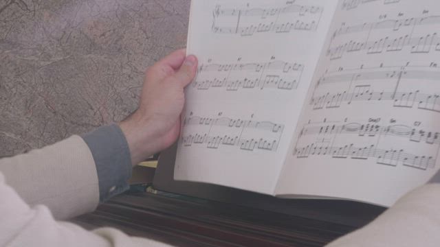 Musician looking for a page in a score book.