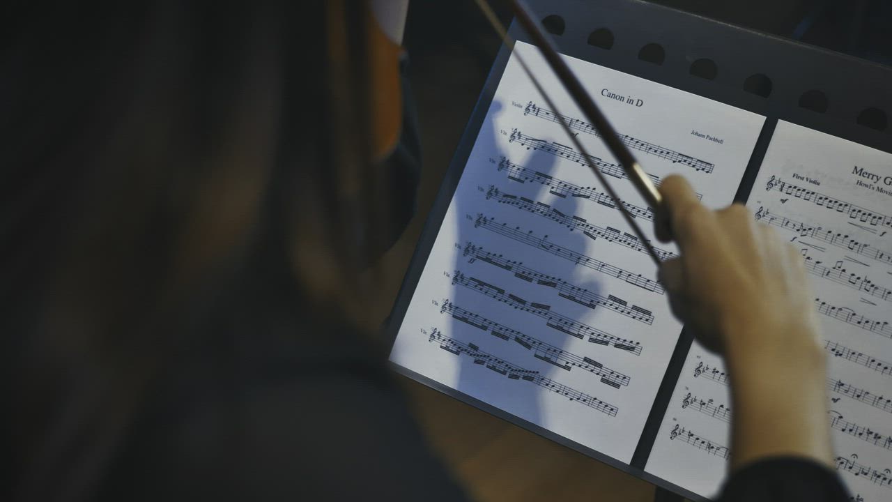 Violinist plays following the notes on a sheet music - Free Stock Video